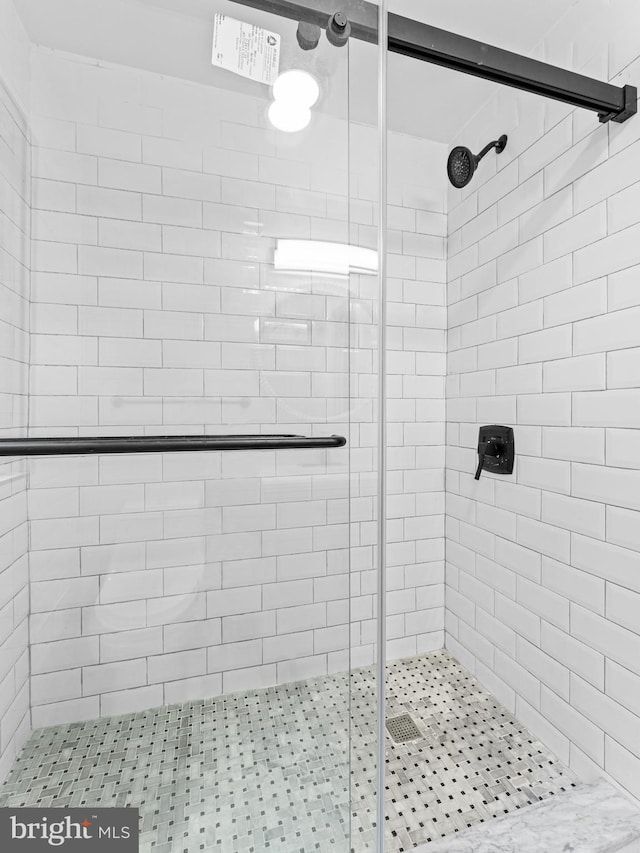 bathroom featuring a shower with shower door