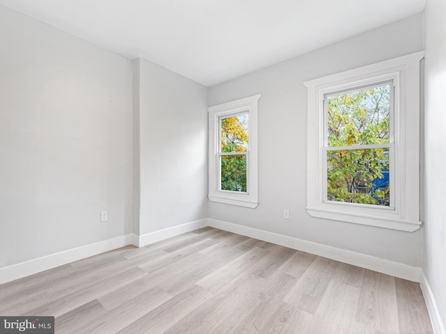 unfurnished room featuring plenty of natural light and light hardwood / wood-style flooring