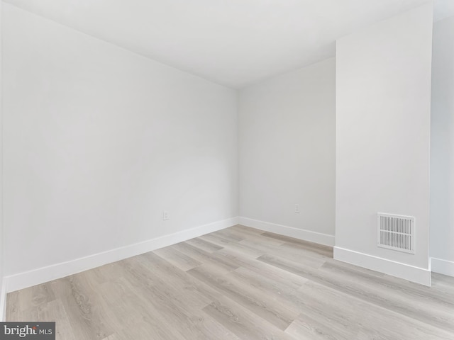 spare room featuring light hardwood / wood-style flooring