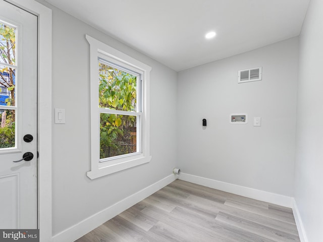 laundry area with hookup for a washing machine and light hardwood / wood-style floors