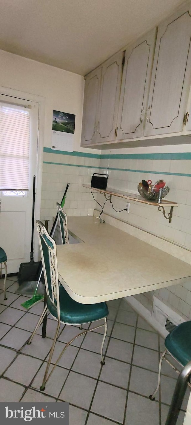 kitchen with white cabinets and light tile patterned flooring