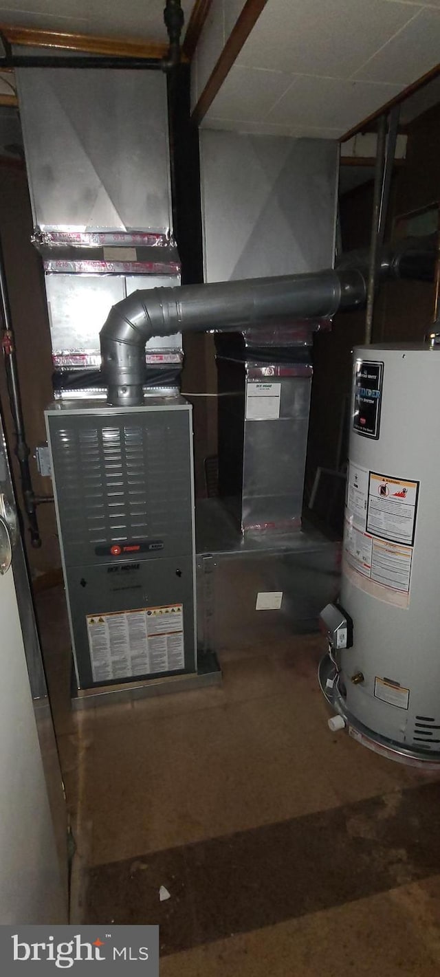 utility room featuring water heater