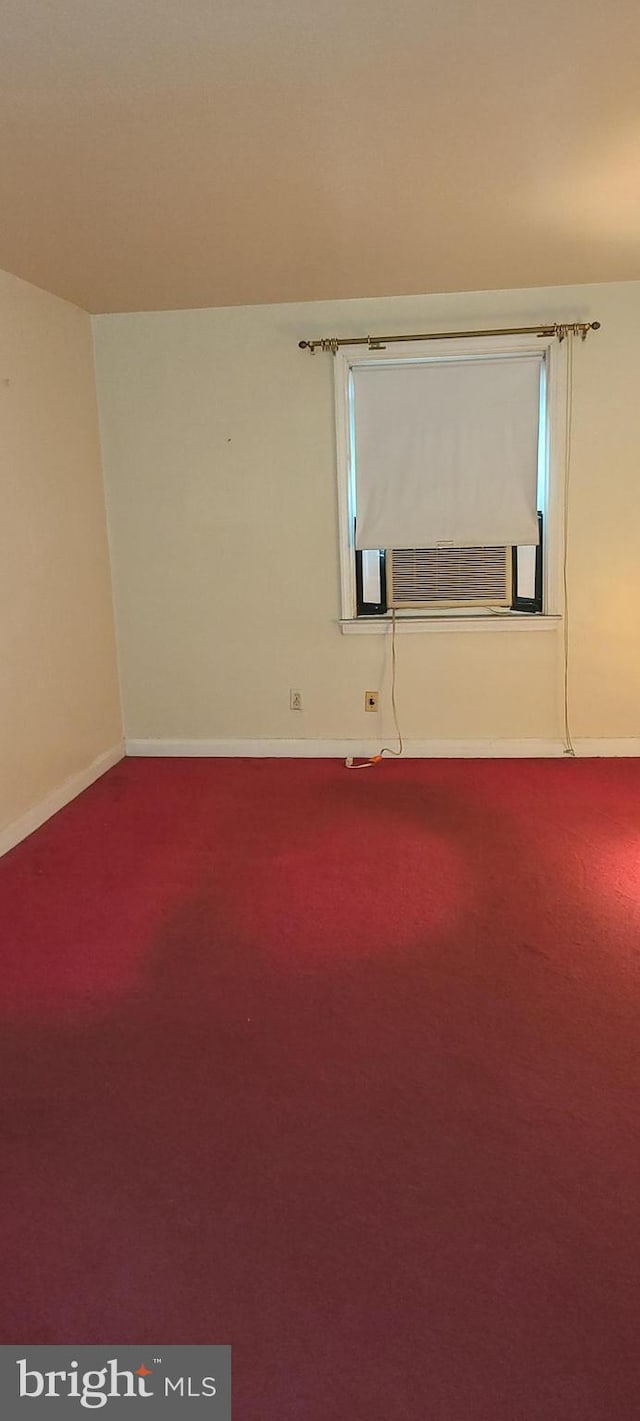 empty room featuring carpet and cooling unit