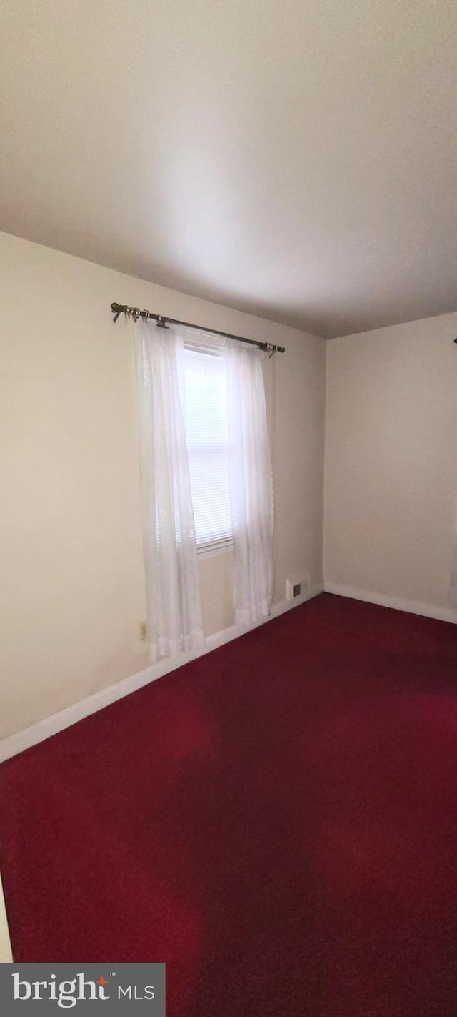 empty room featuring carpet flooring