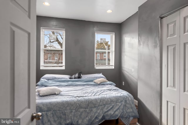 bedroom featuring a closet and multiple windows