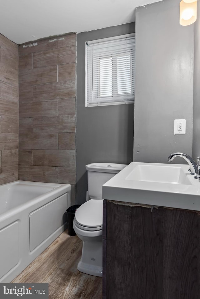 bathroom with sink, hardwood / wood-style floors, and toilet