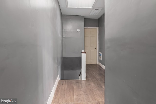 hallway with light hardwood / wood-style floors