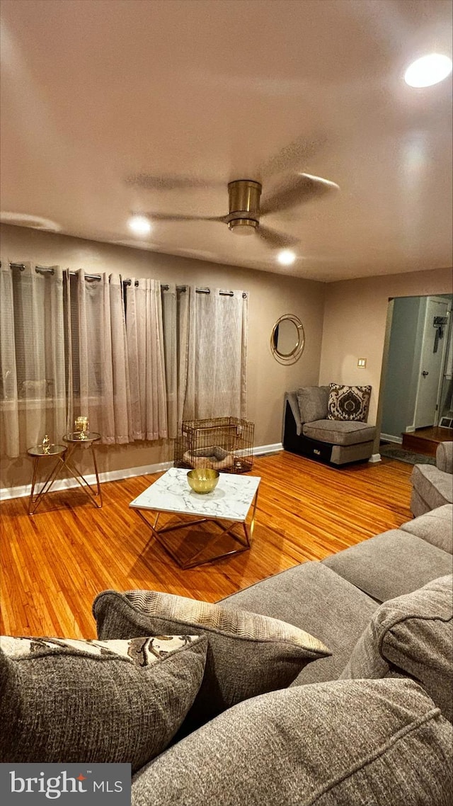 unfurnished living room featuring hardwood / wood-style flooring and ceiling fan