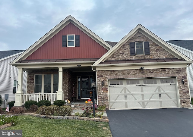 craftsman house featuring a porch, a garage, and a front lawn