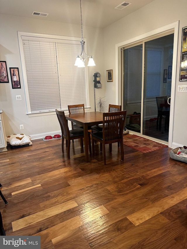 dining room featuring wood-type flooring and a notable chandelier