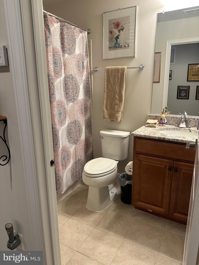 bathroom with tile patterned flooring, vanity, curtained shower, and toilet