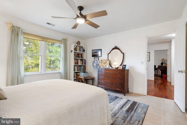 tiled bedroom featuring ceiling fan