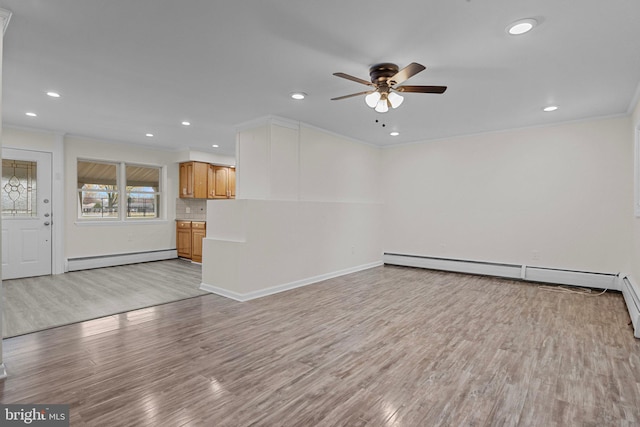 unfurnished living room featuring ceiling fan, crown molding, a baseboard radiator, and light wood-type flooring