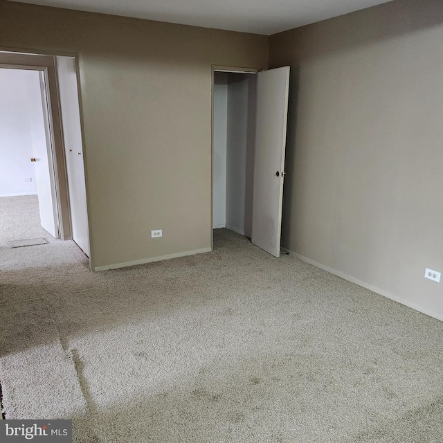 unfurnished bedroom with light colored carpet