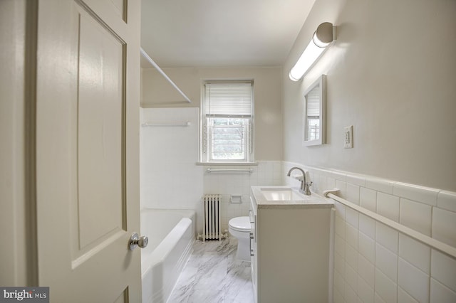 bathroom featuring radiator heating unit, vanity, toilet, and tile walls