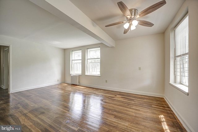 spare room with beamed ceiling, dark hardwood / wood-style floors, ceiling fan, and radiator