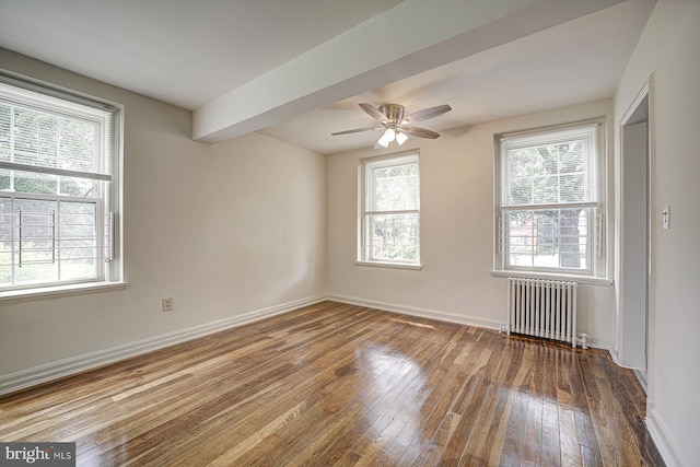 empty room with ceiling fan, radiator heating unit, and hardwood / wood-style flooring