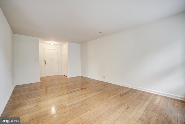 spare room with light hardwood / wood-style flooring