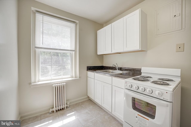 kitchen featuring white range with electric stovetop, radiator, a healthy amount of sunlight, and sink