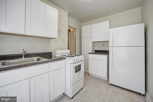 kitchen with light tile patterned flooring, white appliances, white cabinetry, and sink