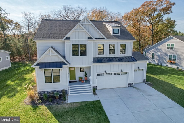 view of front of house with covered porch, a garage, and a front lawn