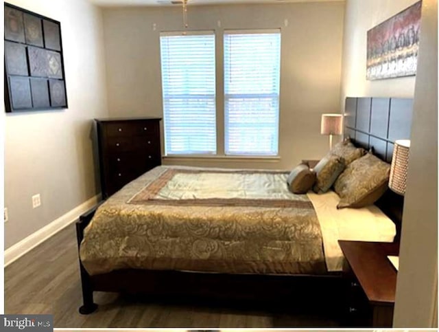 bedroom with dark wood-type flooring