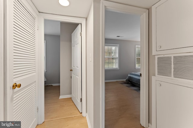 corridor with light hardwood / wood-style floors