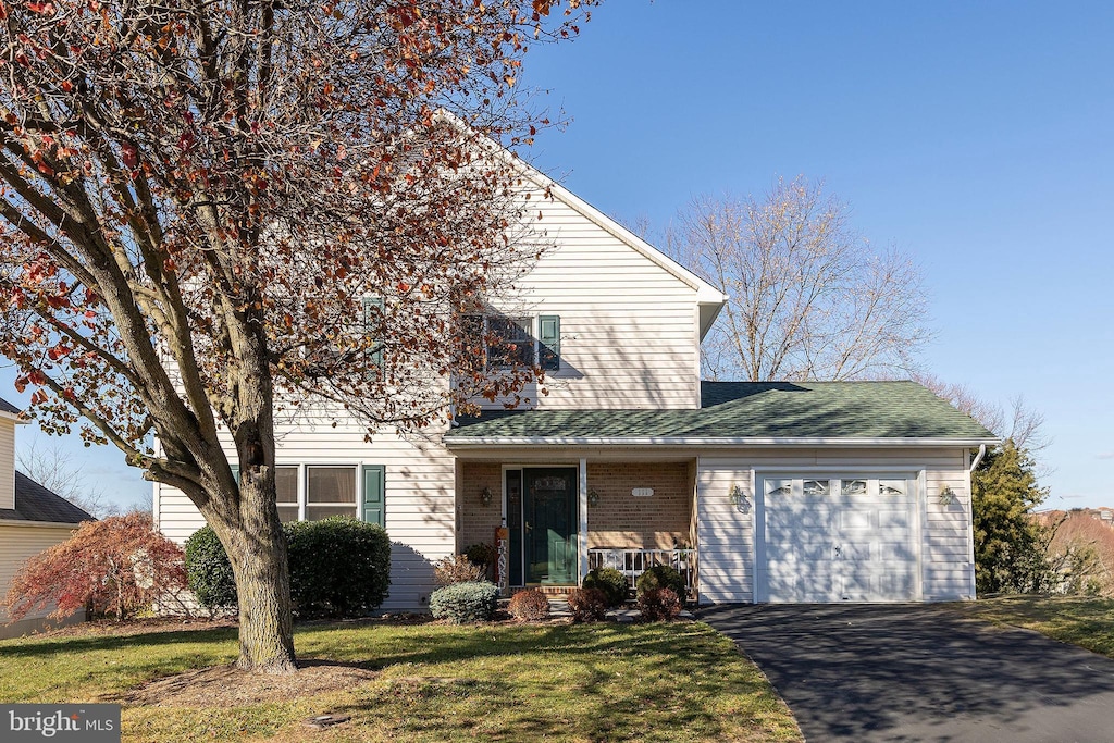 view of front property with a front yard and a garage