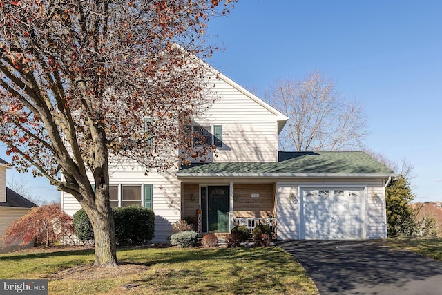 view of front property with a front yard and a garage