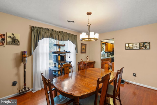 dining space featuring a chandelier and dark hardwood / wood-style floors