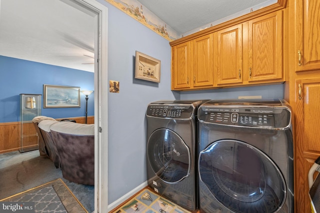 laundry room with dark carpet, cabinets, a textured ceiling, and washing machine and clothes dryer