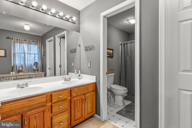 bathroom featuring vanity, tile patterned flooring, toilet, a textured ceiling, and walk in shower