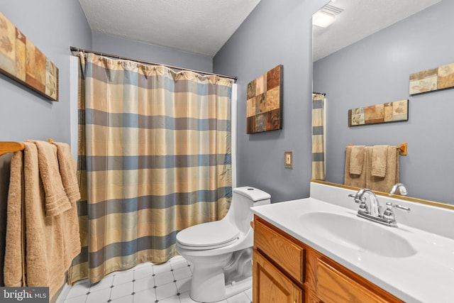 bathroom with vanity, a textured ceiling, toilet, and tile patterned flooring