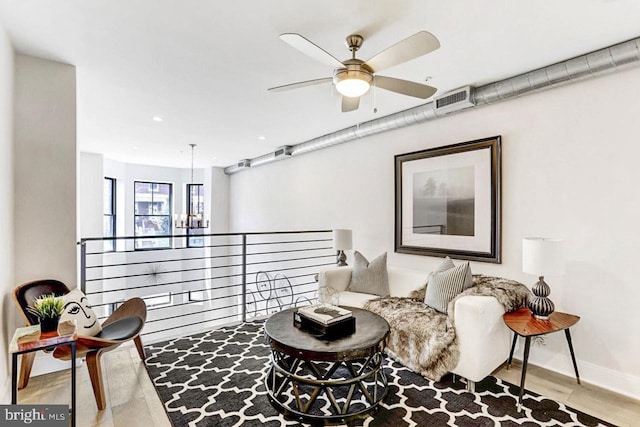 living room with ceiling fan and light wood-type flooring