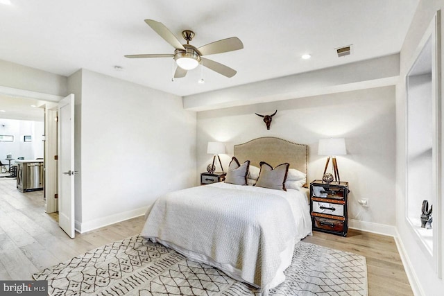 bedroom with light hardwood / wood-style floors and ceiling fan