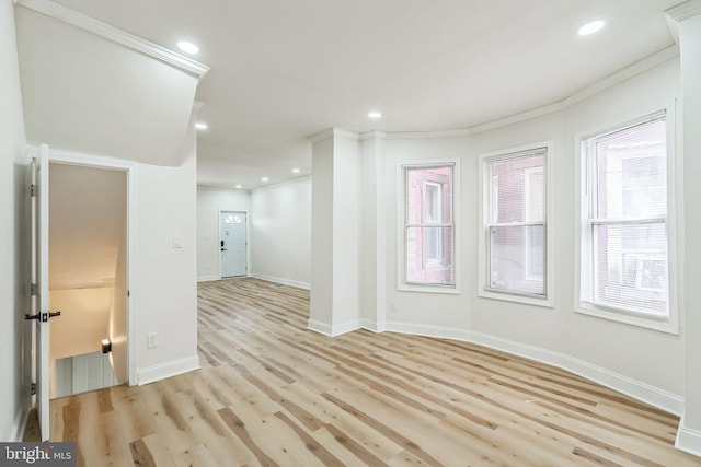 empty room featuring light hardwood / wood-style floors and ornamental molding