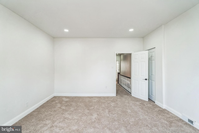 unfurnished room with light carpet