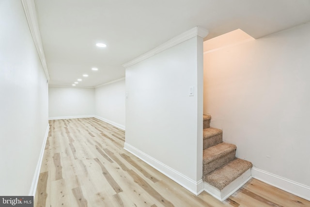 interior space featuring wood-type flooring and crown molding