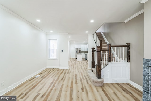 entrance foyer featuring light hardwood / wood-style floors and ornamental molding