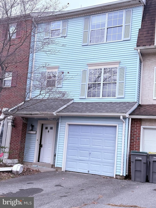 townhome / multi-family property featuring a garage