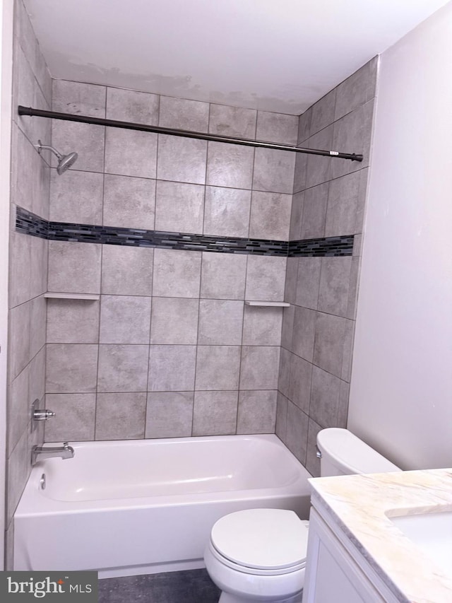 full bathroom featuring vanity, toilet, and tiled shower / bath