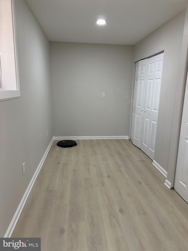 unfurnished bedroom featuring a closet and light hardwood / wood-style flooring