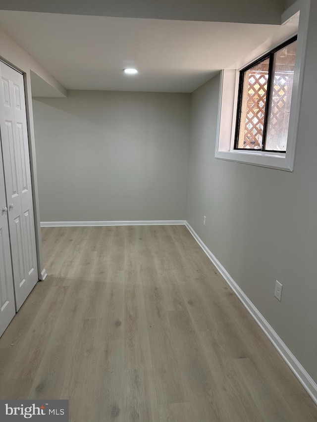 basement with light hardwood / wood-style floors