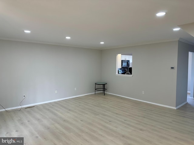 interior space with light hardwood / wood-style floors and crown molding