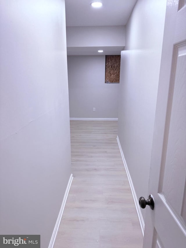 hallway with light hardwood / wood-style floors