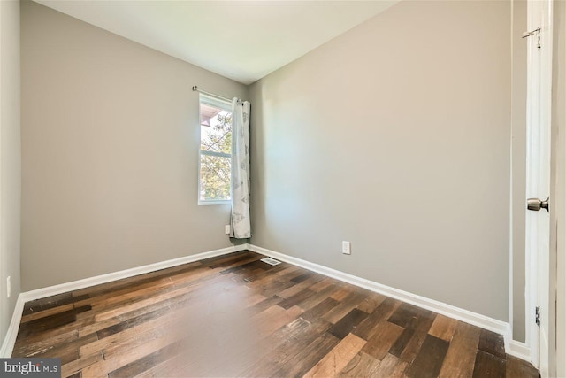 spare room with dark hardwood / wood-style floors