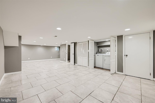 basement with light tile patterned floors and washer and clothes dryer