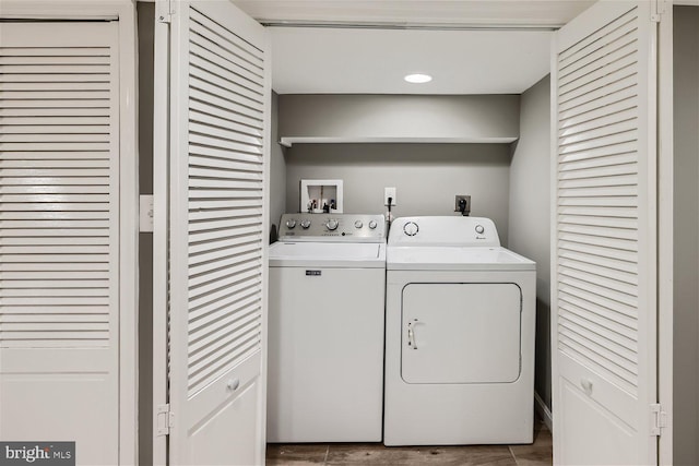 clothes washing area with washing machine and dryer