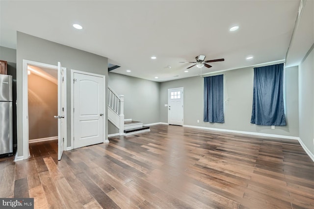 interior space featuring stainless steel fridge, wood-type flooring, and ceiling fan