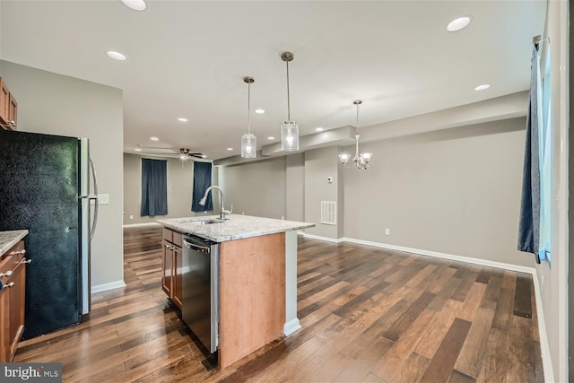 kitchen featuring black refrigerator, stainless steel dishwasher, sink, decorative light fixtures, and a center island with sink